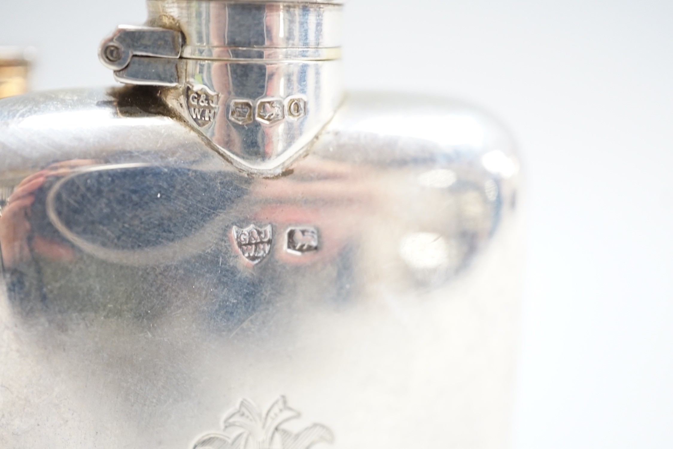 Two George V silver hip flasks, one with engine turned decoration, the latter William Base & Sons, Birmingham, 1927, 10.7cm, 7.7oz.
